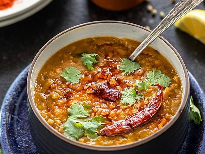 A bowl of soup with a spoon in it