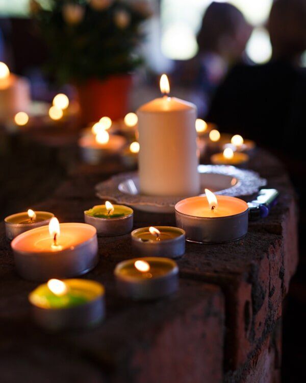 Urn, Candle And A Picture Frame On A Table — Quality Cremation Services in Rockhampton, QLD