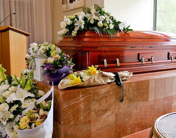 Flowers And Casket — Quality Cremation Services in Rockhampton, QLD