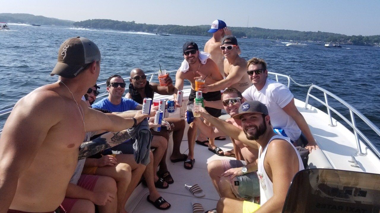 bachelor party cheers on boat taxi at Ozarks