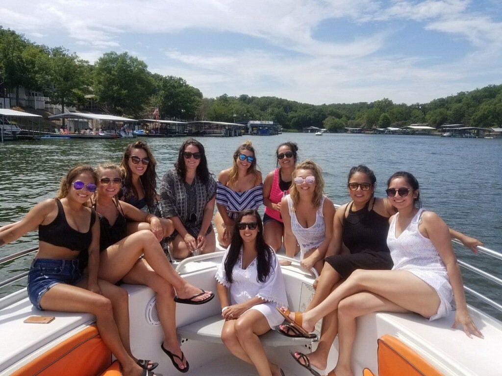 bride posing in the center of bachelorette party on Lake of the Ozarks Water Taxi boat taxi
