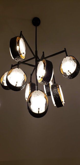 A chandelier with a lot of lights hanging from the ceiling.