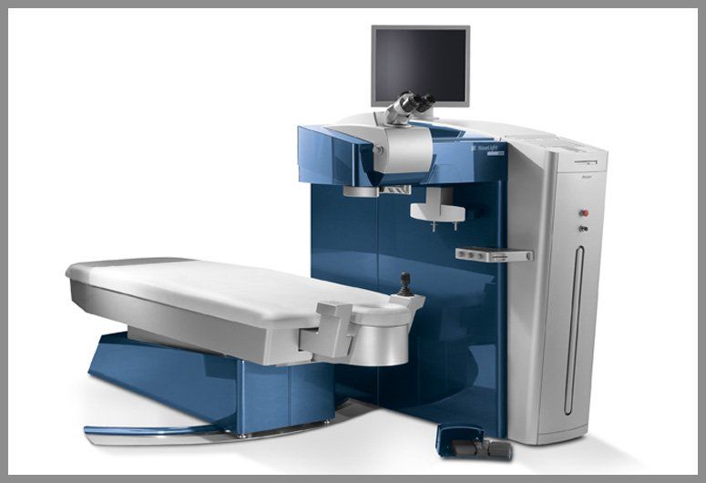 A blue and white machine with a monitor on top of it