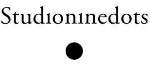 Black text “Studioninedots” above a centered black dot on a white background