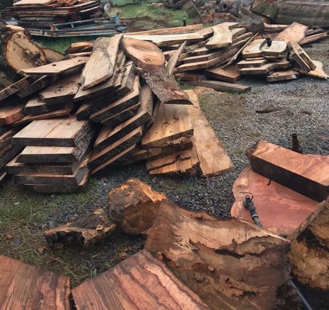 Unstacked green live edge slabs.
