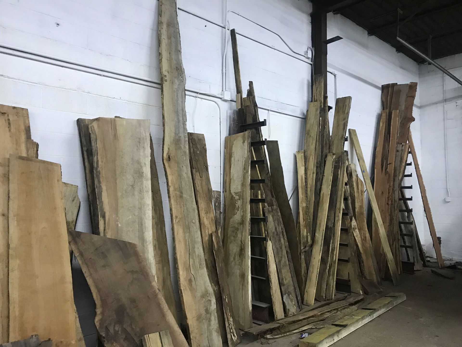 Live edge slabs stored vertically.
