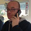 man talking on a landline phone