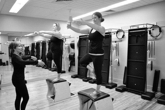A group of women are doing pilates exercises 