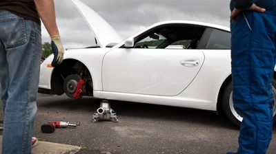 Assisting motorist with flat tire Assisting motorist with flat tire