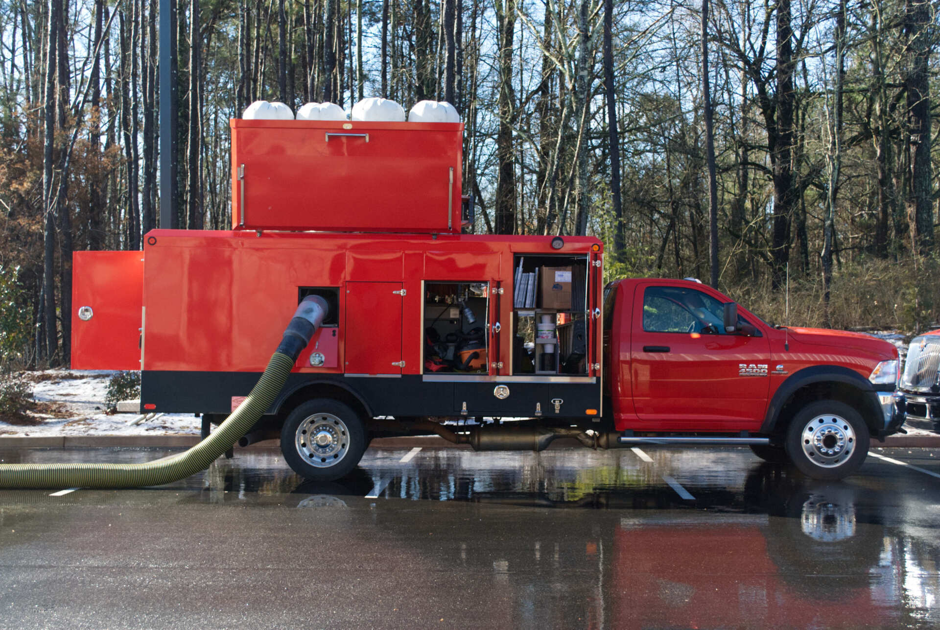 A red truck with a hose attached to it