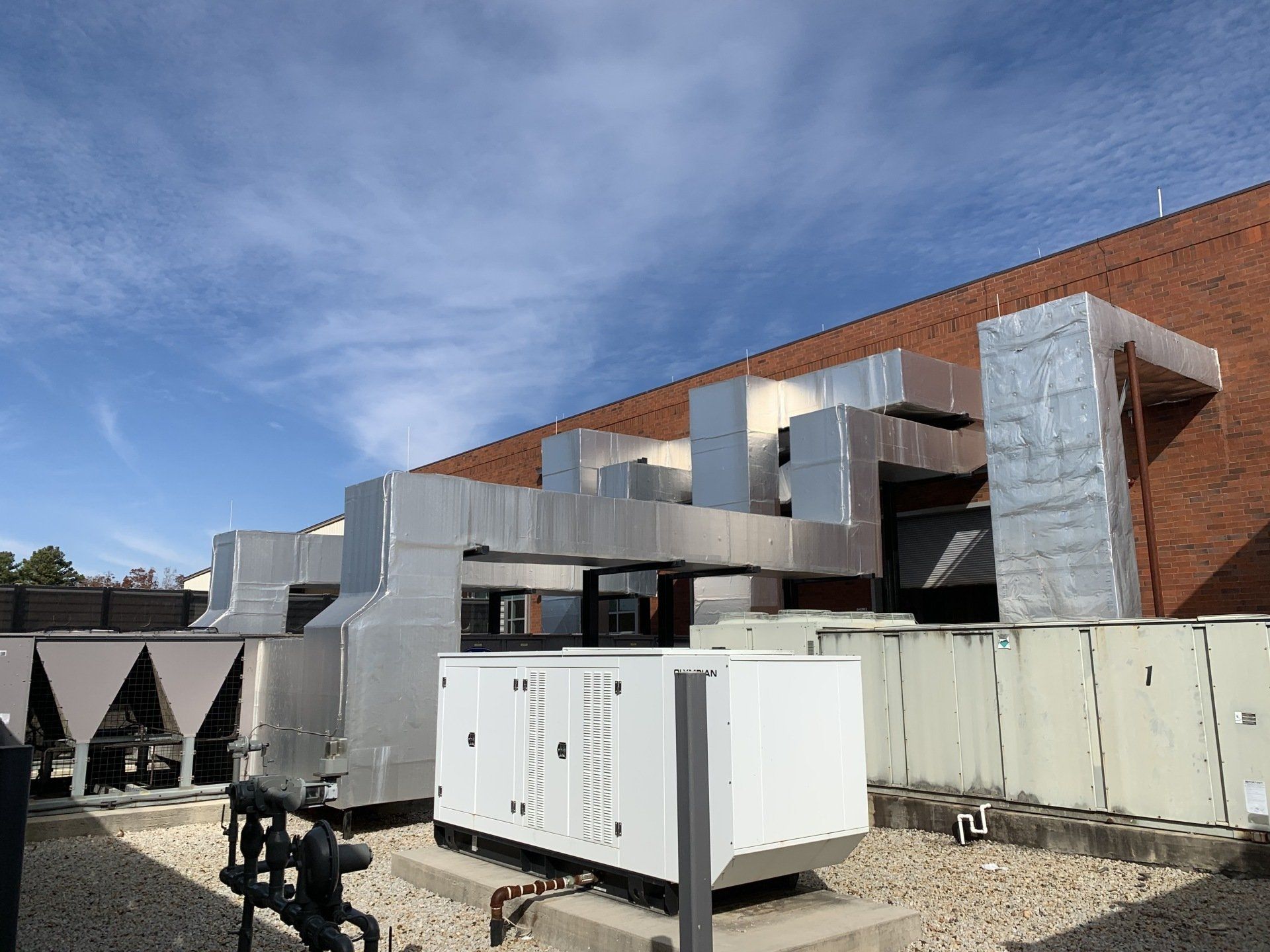A large building with a lot of air ducts on the roof.
