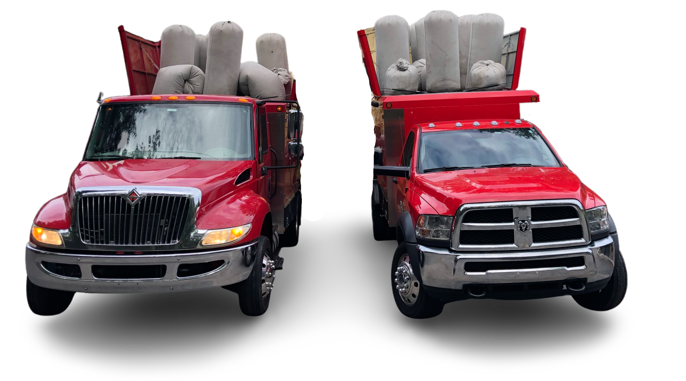 Two red trucks are parked next to each other on a white background.