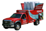 A red truck with foam bags on top of it