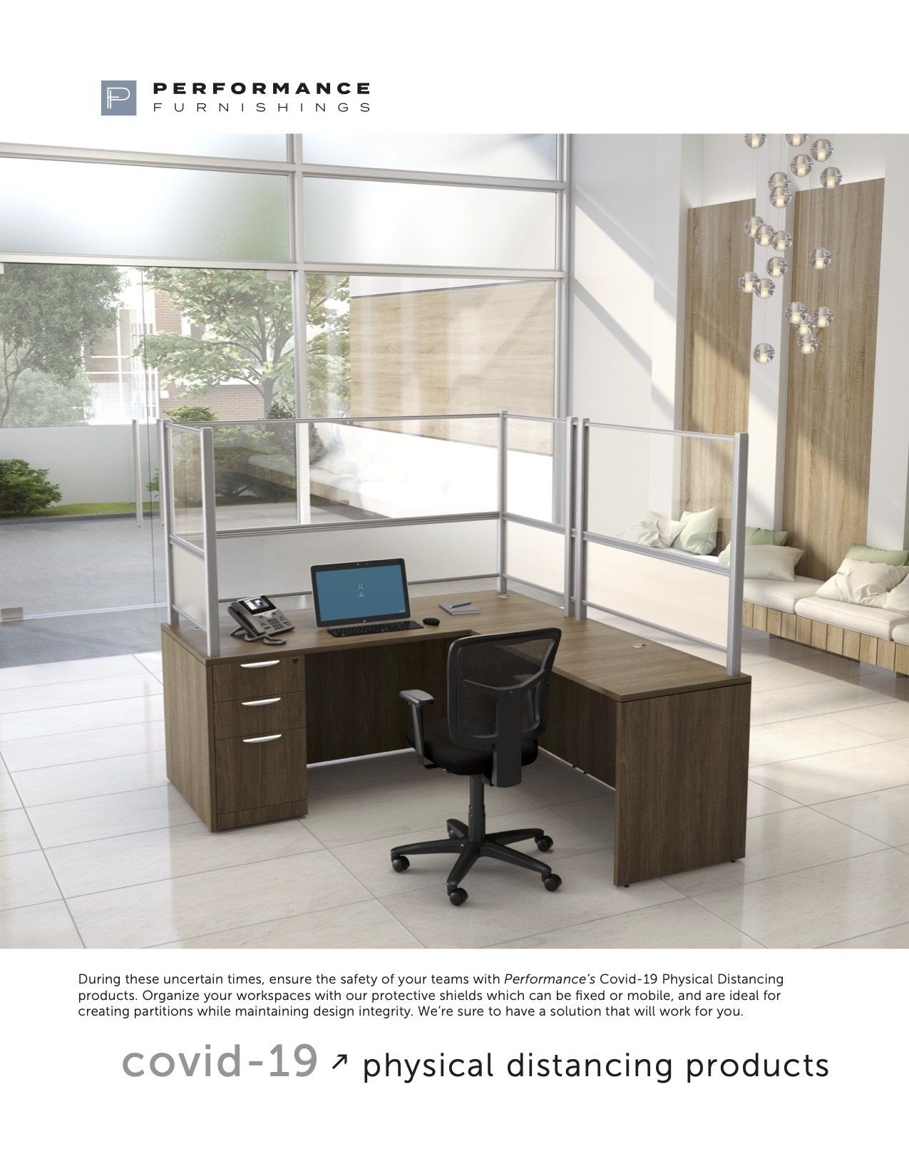 L-shaped office desk with clear dividers, phone, laptop, and chair. 