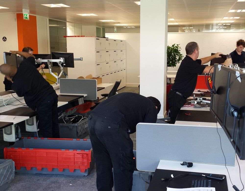 A group of men are working in an office setting