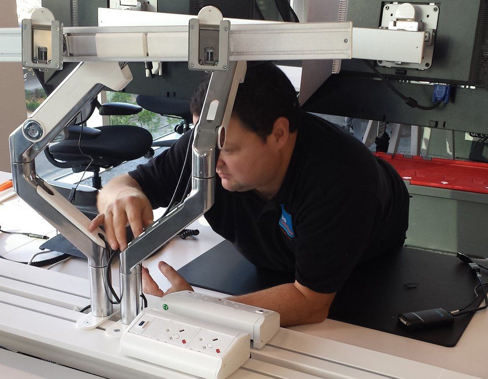 A man in a black shirt is working on a computer