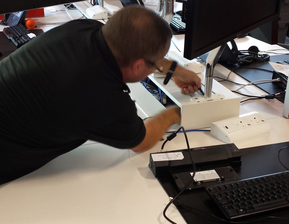 A man in a black shirt is working on a computer