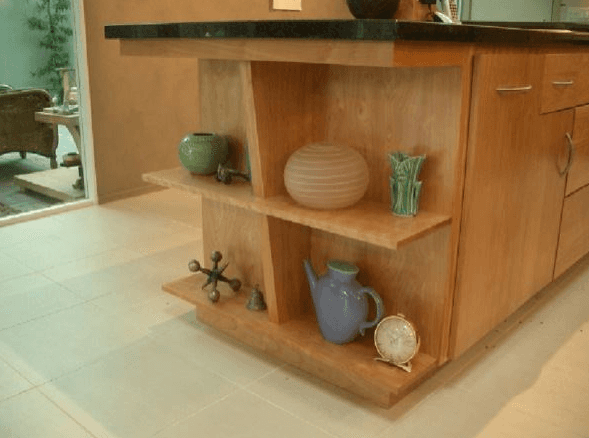 Close up of wood kitchen island with custom built-in shelving