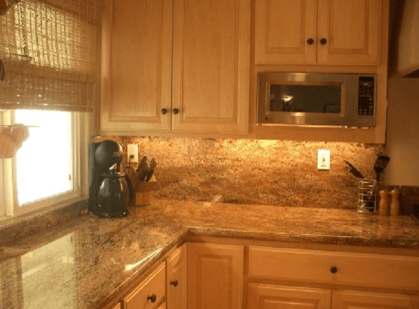 Close up of marble kitchen counter top and custom cabinets