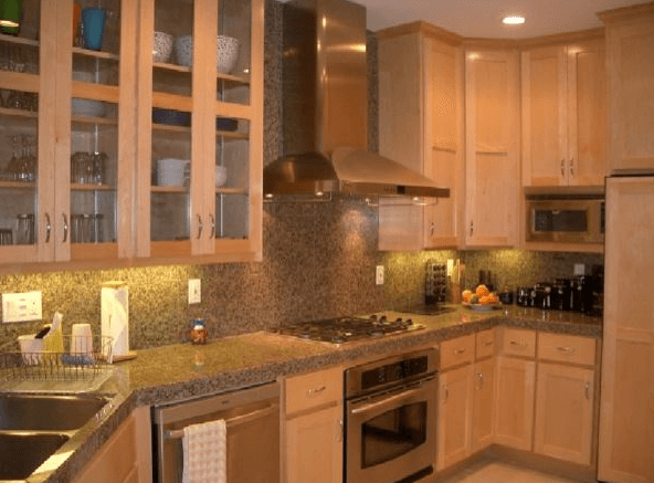 Full kitchen remodeling project with custom cabinets, marble counter tops, and built-in oven range