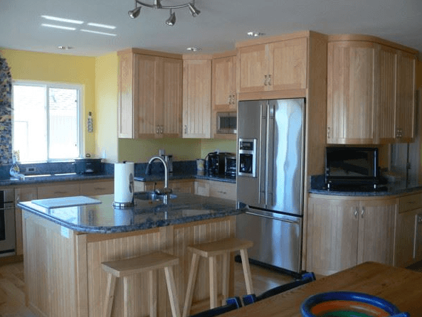 Full-scale kitchen remodeling project with rounded edge custom cabinets