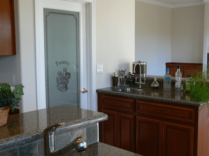 Completed kitchen remodeling project with frosted glass pantry door