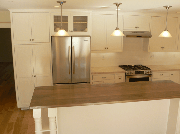 Full kitchen remodeling design with clean white custom cabinets and stainless steel appliances