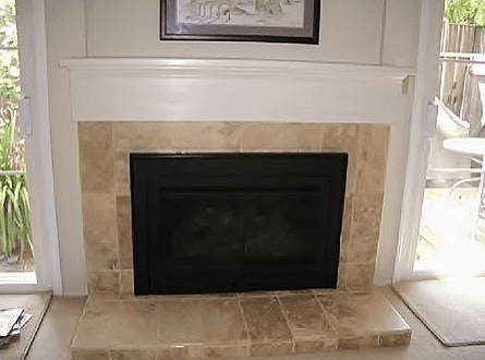 picture hanging next to fireplace mantel