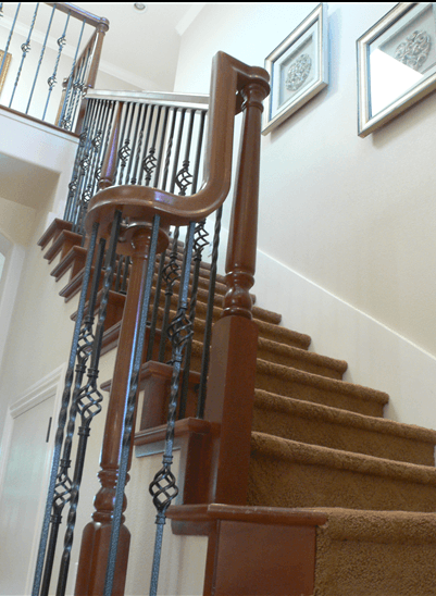 Indoor stairway with winding wood and iron railing