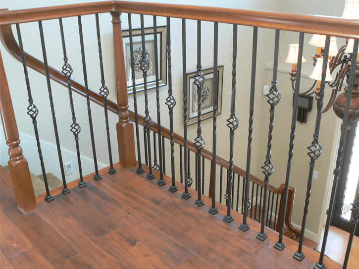 Indoor stairway with winding wood and iron railing