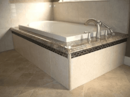 Square corner bathtub with custom stone and quartz details