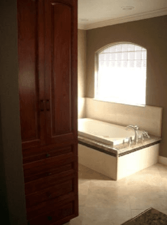Full view of a bathroom with a square bathtub and custom stone and quartz details