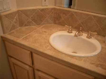 bathroom vanity with a custom stone finish around an oval sink