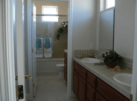 Dual bathroom vanity outside of the larger bathroom area