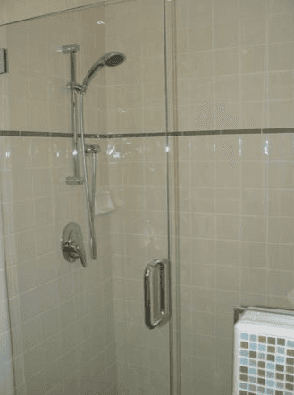 Custom white tile work with a gray border inside a walk-in shower