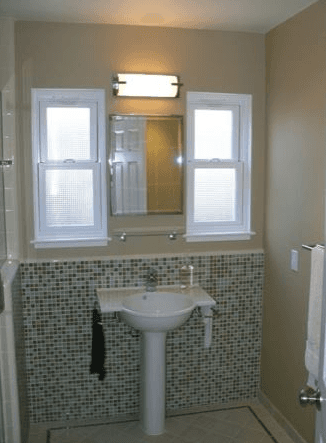Custom tile work design around a pedestal sink