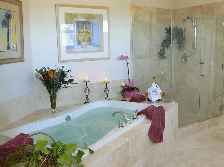 Custom stone bathtub with candles and champagne