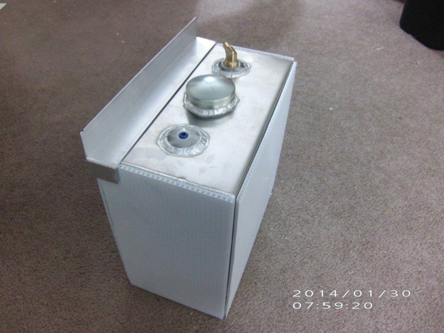 A stainless steel box is sitting on a carpeted floor