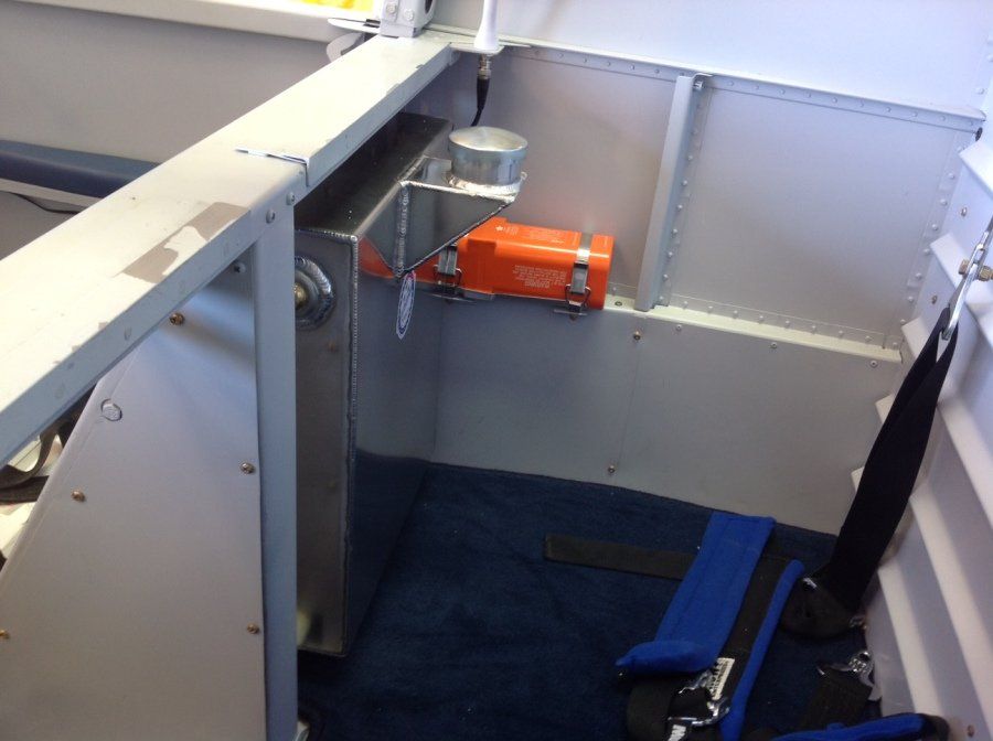 A small orange box is hanging on a wall in a room