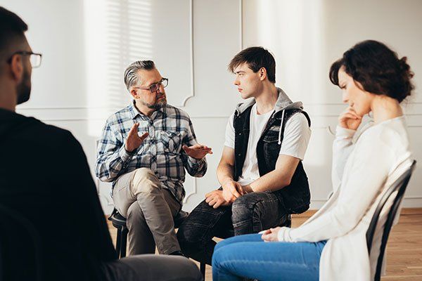 Positive Professor Having Discussion — Oklahoma City, OK — A Better Choice Counseling A group of people working on substance abuse counseling in Oklahoma City, OK
