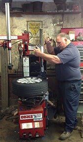 Man in Repairing Tire Shop - Tire Repair in Northampton, MA Man in Repairing Tire Shop - Tire Repair in Northampton, MA