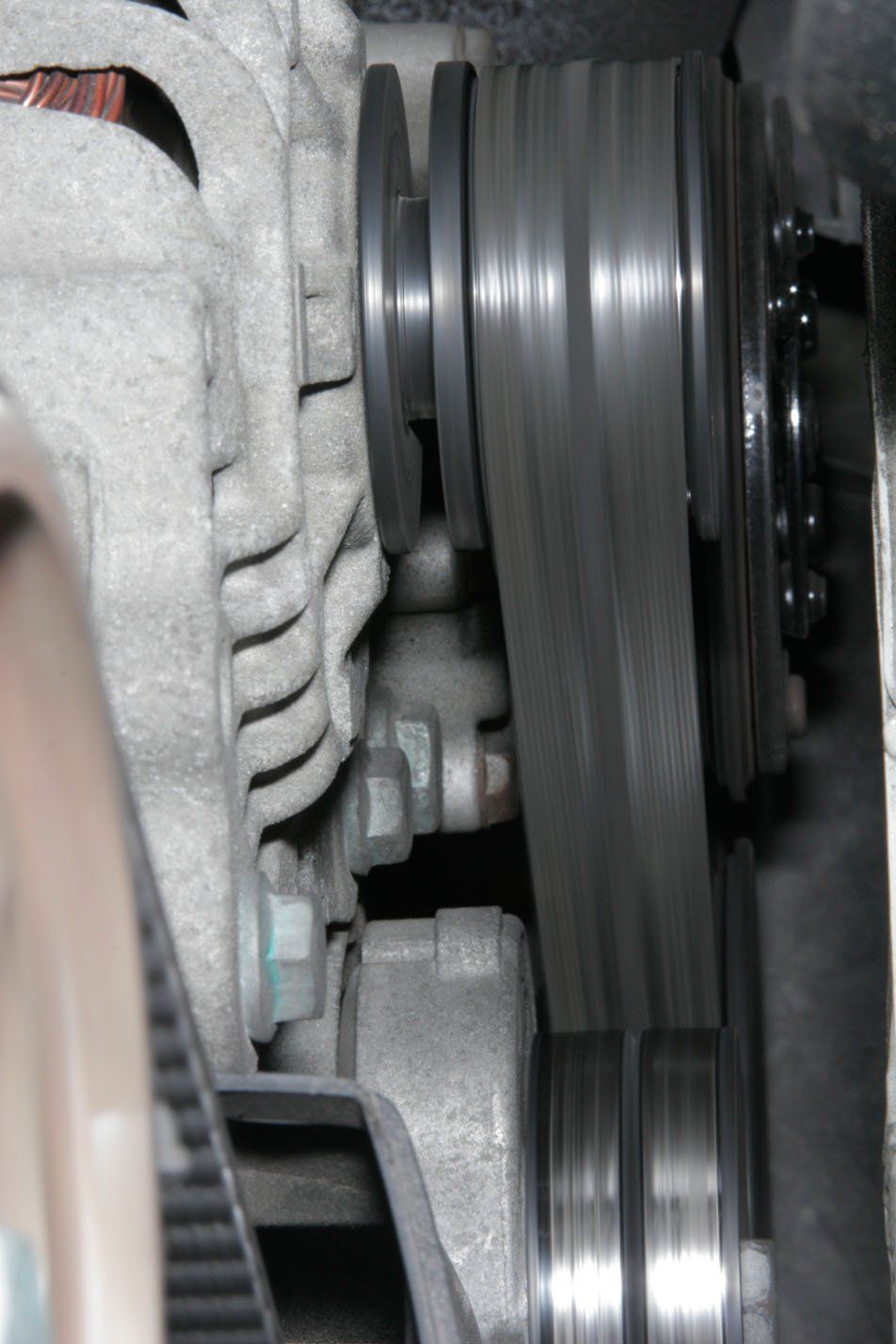 Large fan of heating/cooling system. Fan blades are motion blurred, grill is sharp.
