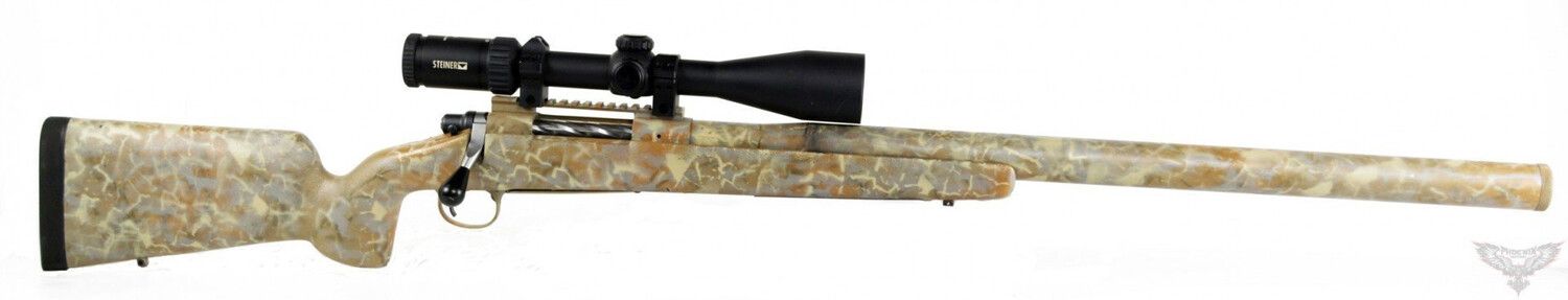 CUSTOM INTEGRALLY SUPPRESSED BOLT ACTION RIFLE A camouflage hunting rifle with a scope, against a white backdrop.