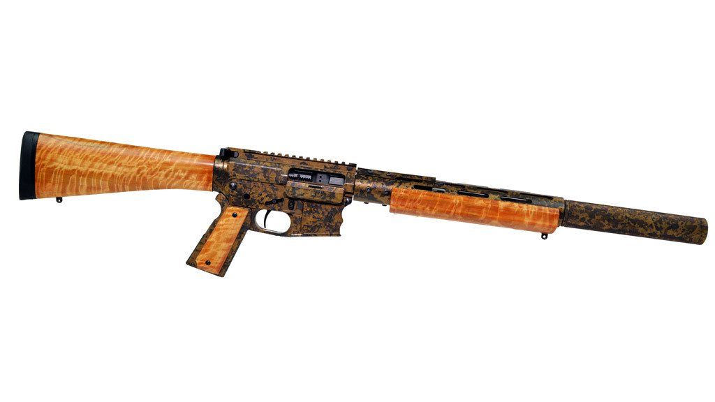 A shotgun with wooden and dark camo detailing.