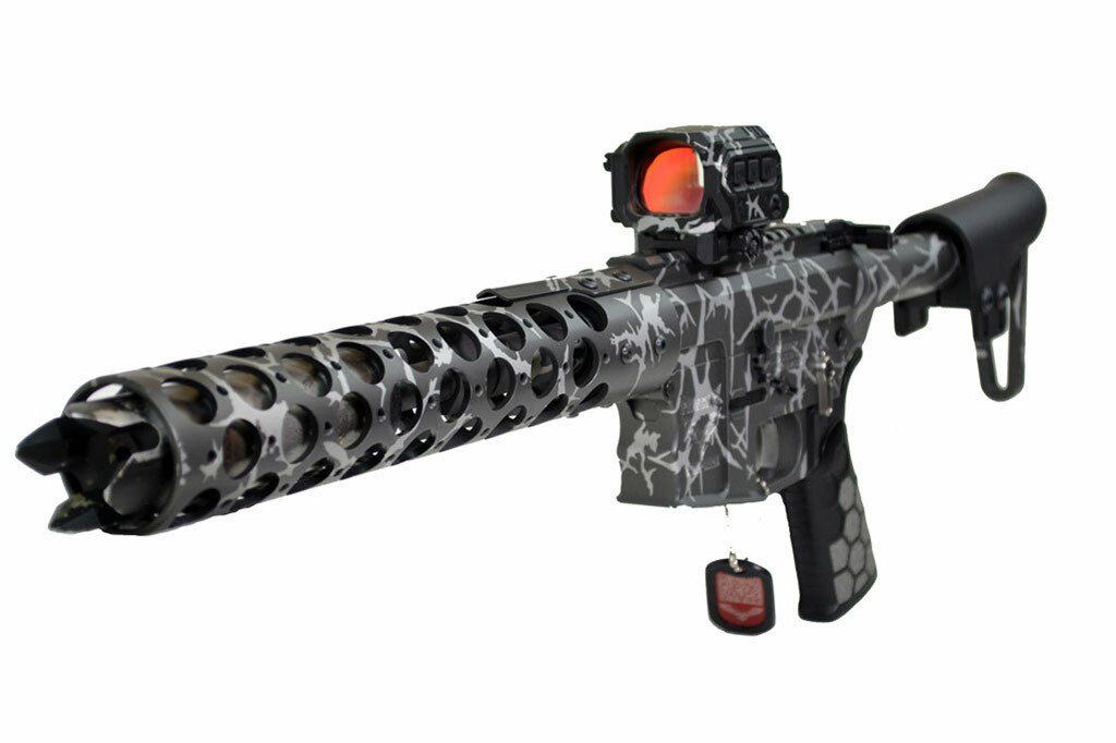 Gray-patterned rifle with a red dot sight and a perforated barrel.