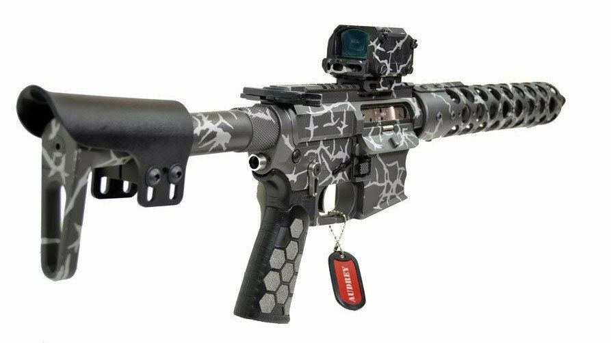 Custom AR-15 style rifle with a black and gray cracked paint pattern, equipped with a red dot sight.