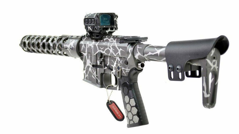 Custom AR-15 style rifle with gray and white cracked camouflage pattern, red dot sight, and a black stock.