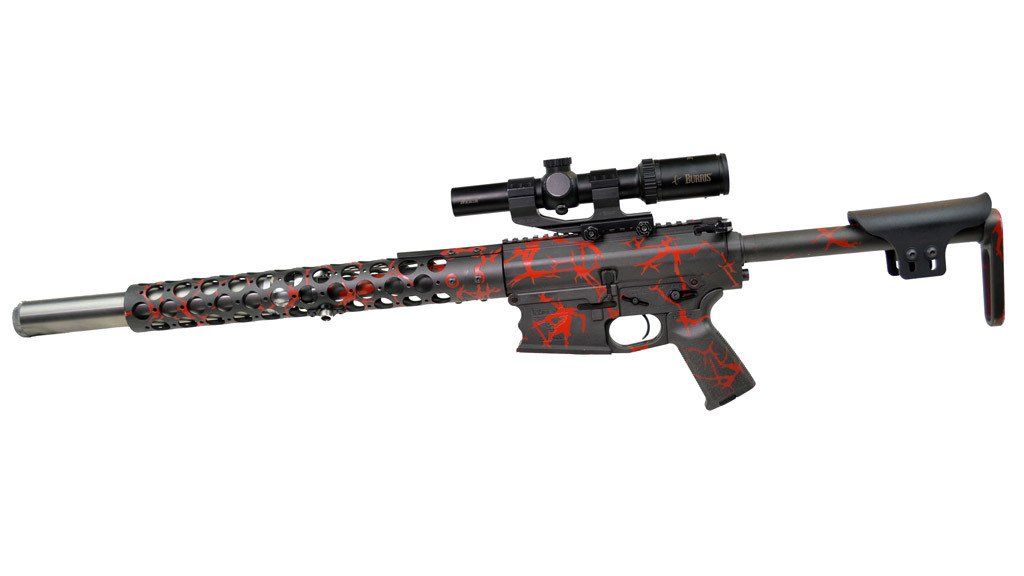 AR-15 style rifle with red and black camouflage paint, mounted scope, and extended barrel.