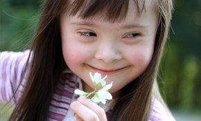 Baby holding a flower in hand