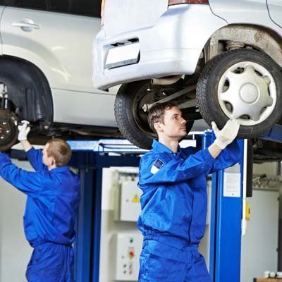 Two repair man installing car wheel - Walt's Auto Service Center, Taunton, MA Two repair man installing car wheel - Walt's Auto Service Center, Taunton, MA
